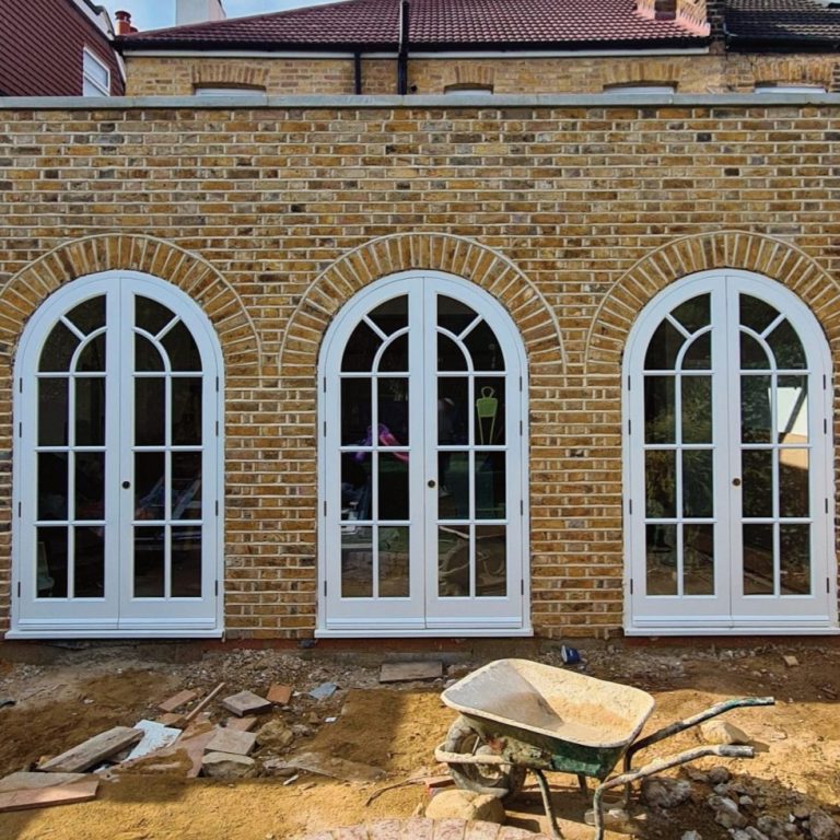 Arched wooden windows in a yellow brick building in kent
